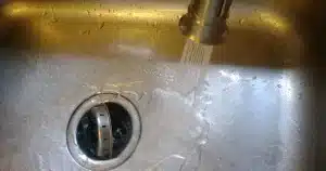 Faucet running in kitchen sink